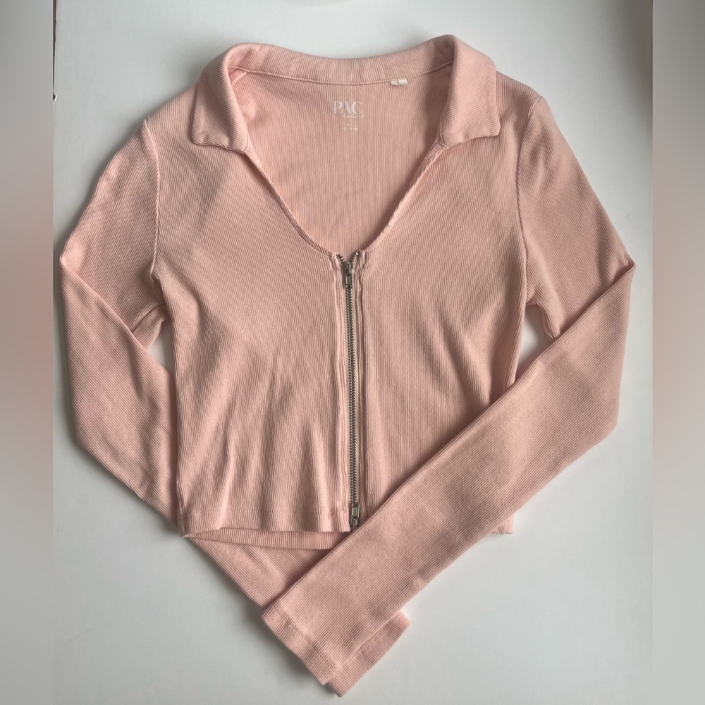 Tight pink long sleeve crop top.